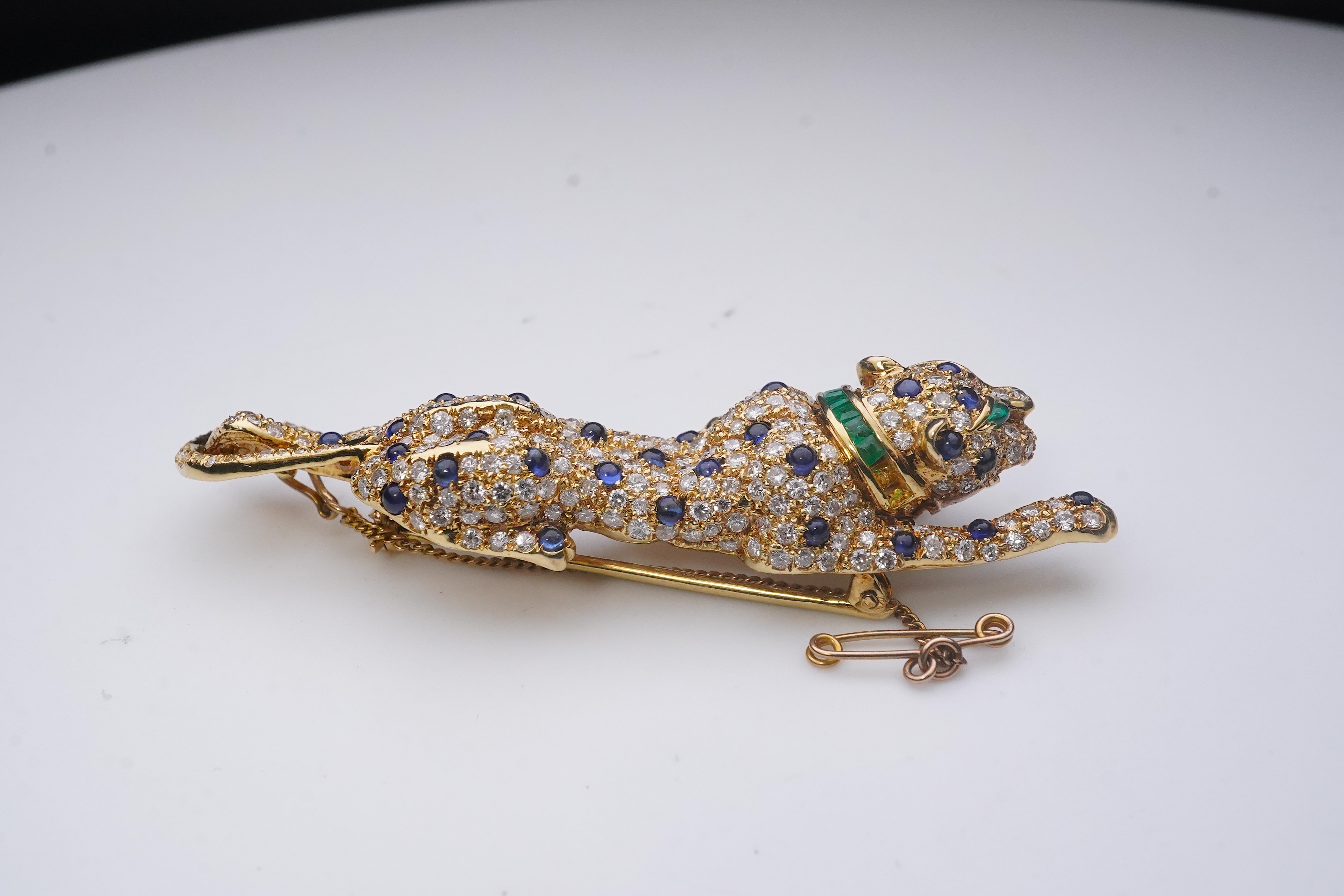 A sapphire, emerald and diamond brooch